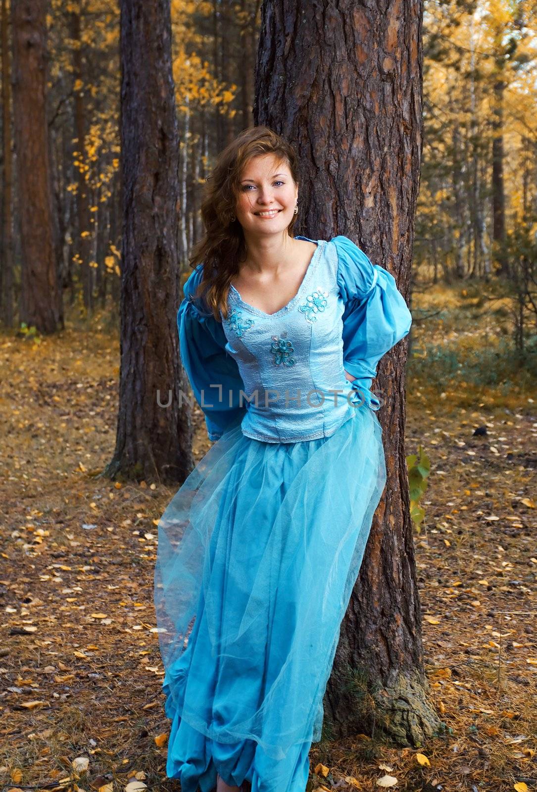 Very beautiful girl in medieval dress in autumn wood