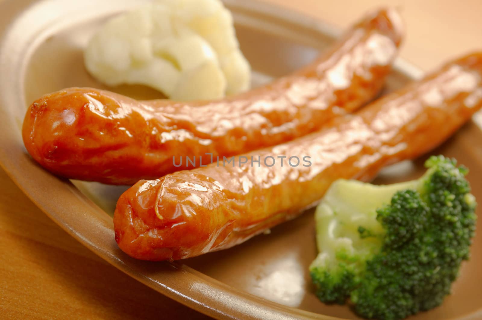 Sausages with broccoli and cauliflower . close up . Shallow depth-of-field