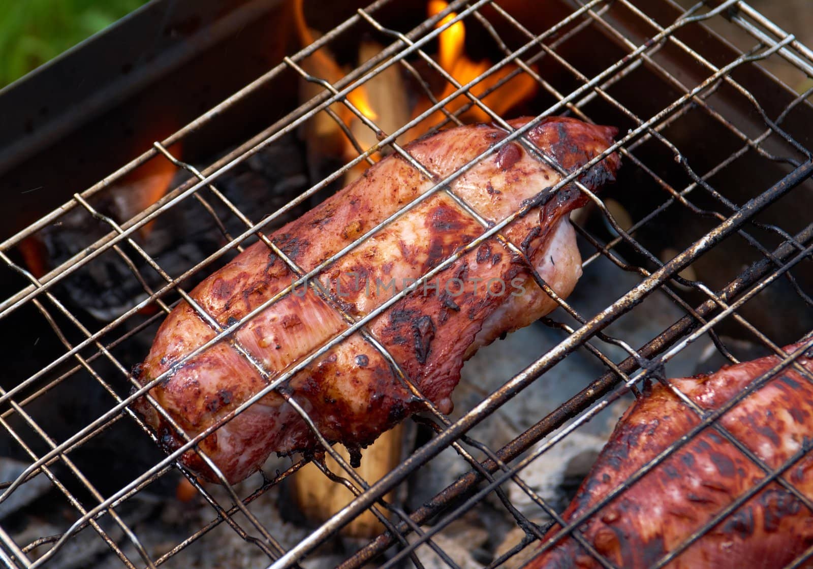 barbecue.chicken on the grill with flames
