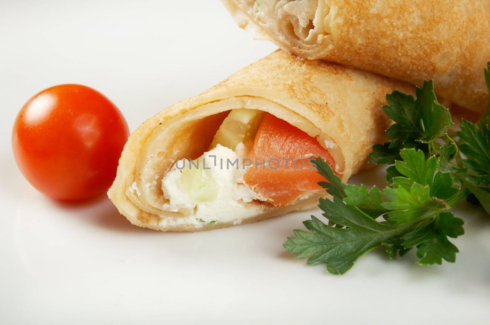 rolled pancakes stuffed chicken. Shallow depth-of-field.