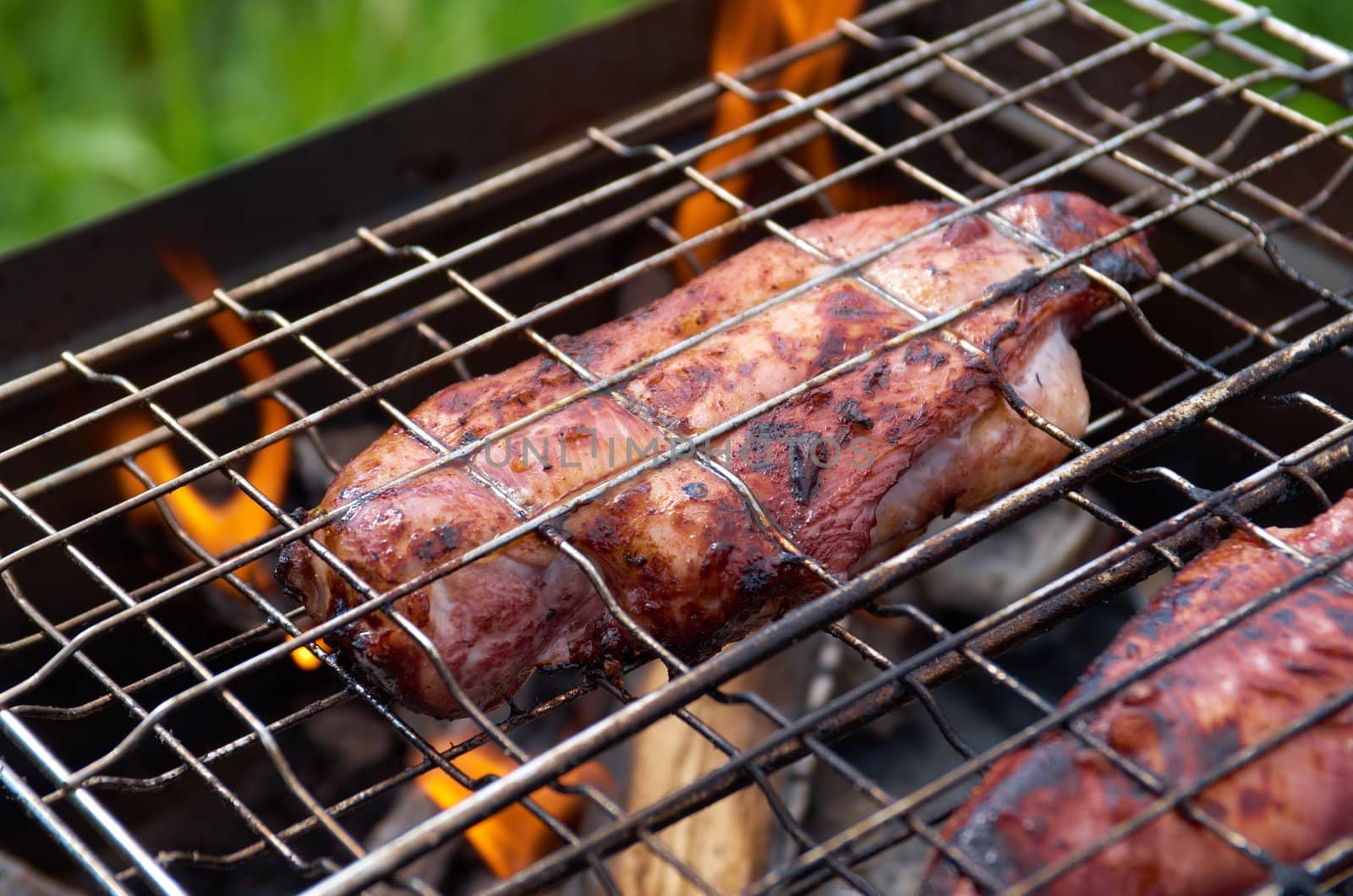 barbecue.chicken on the grill with flames