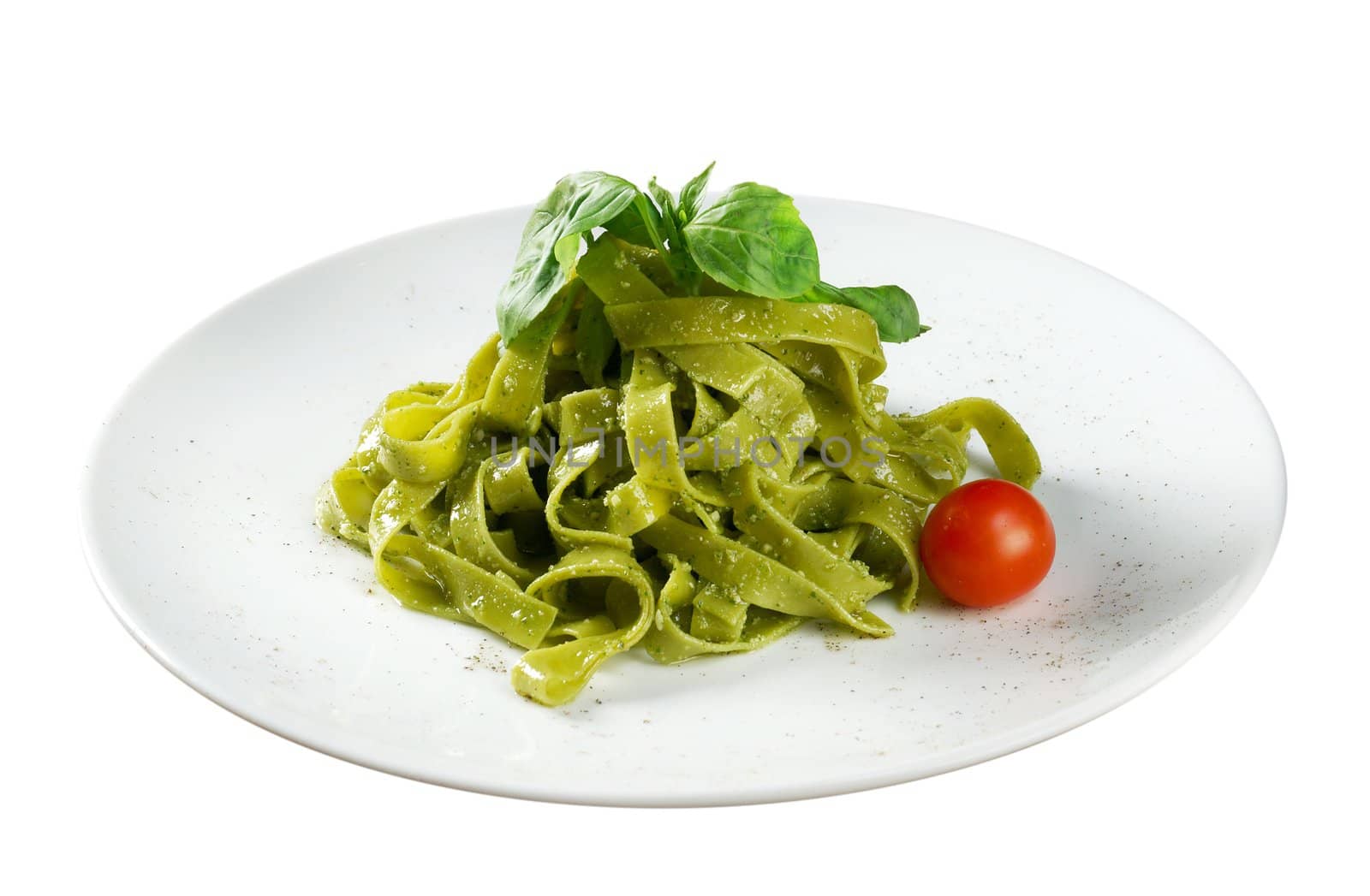 Tagliatelle pasta with pesto on light plate. closeup