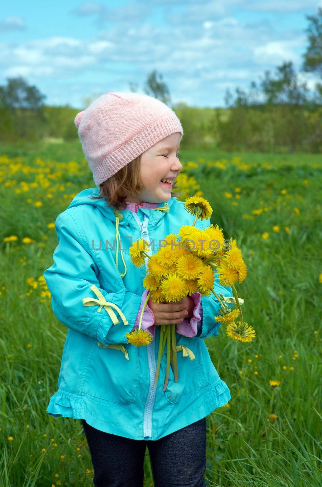 small girl  on meadow with dandelion