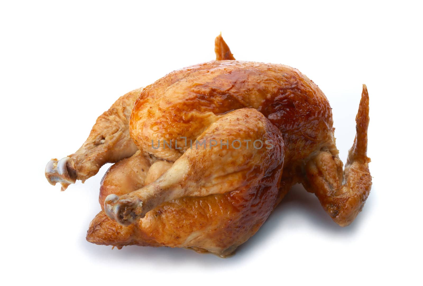 Whole grilled chicken on white background.