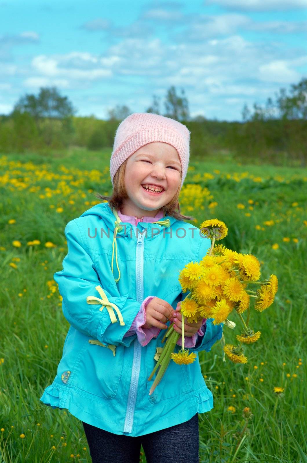 small girl  on meadow with dandelion