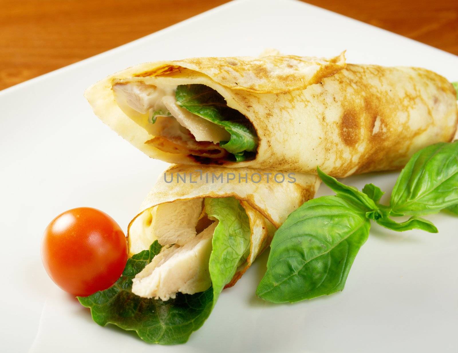 rolled pancakes stuffed chicken. Shallow depth-of-field.
