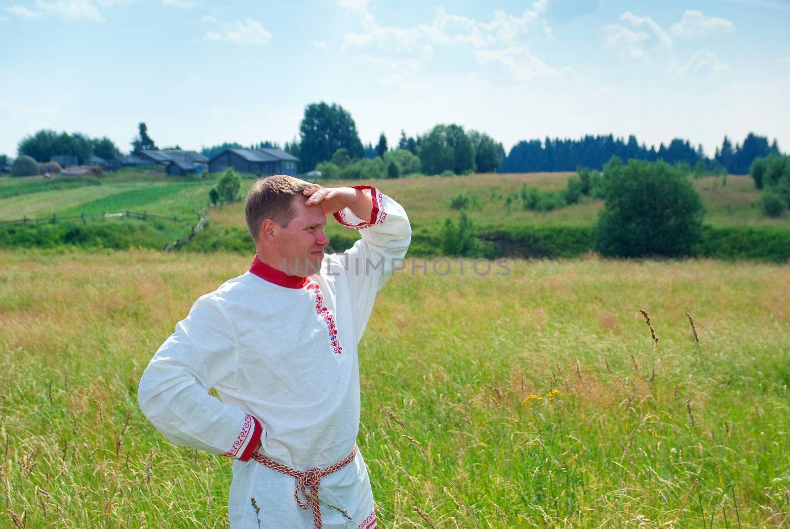 man  in national Russian clothes  in countryside