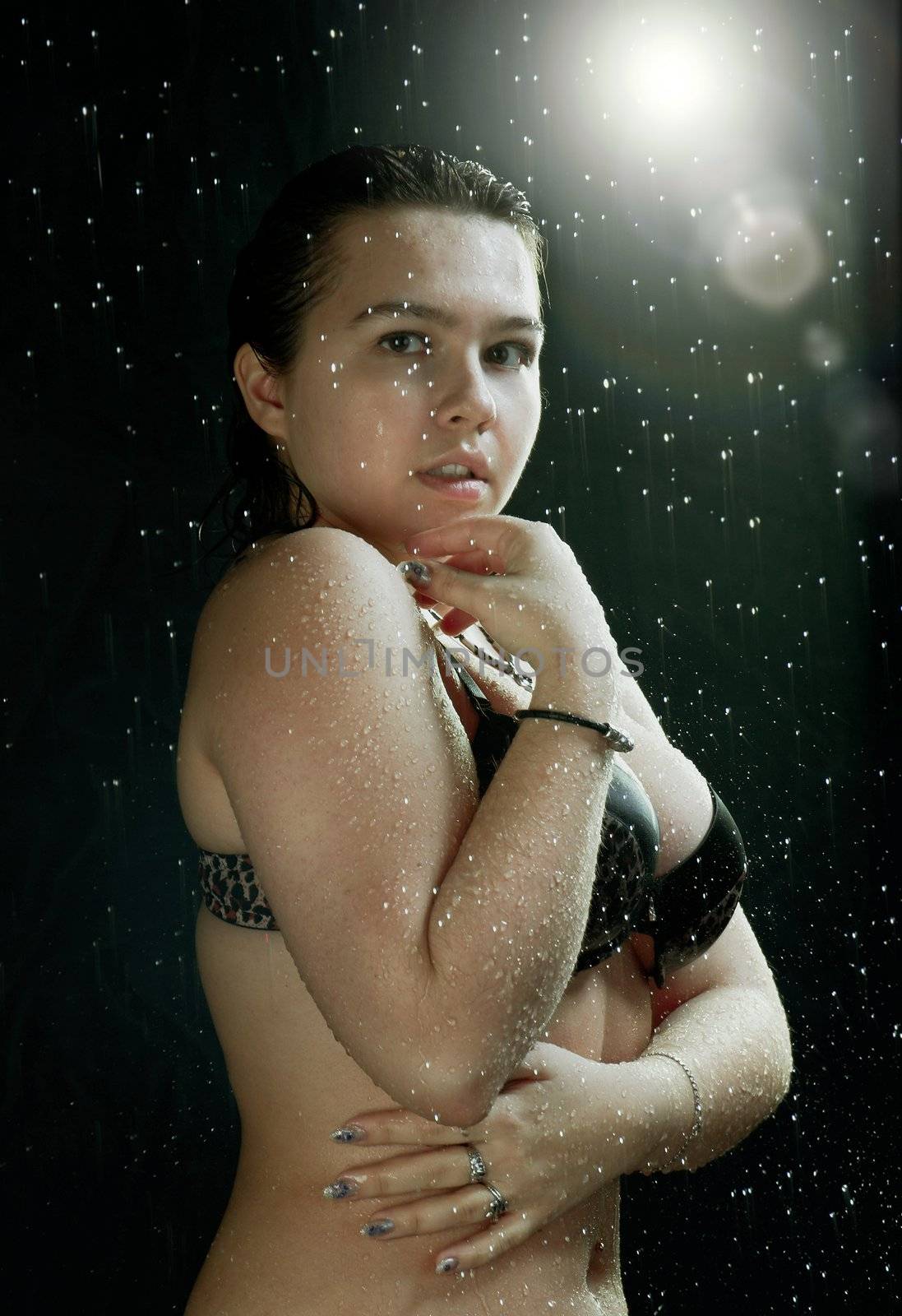 Young sexy woman water studio portrait.