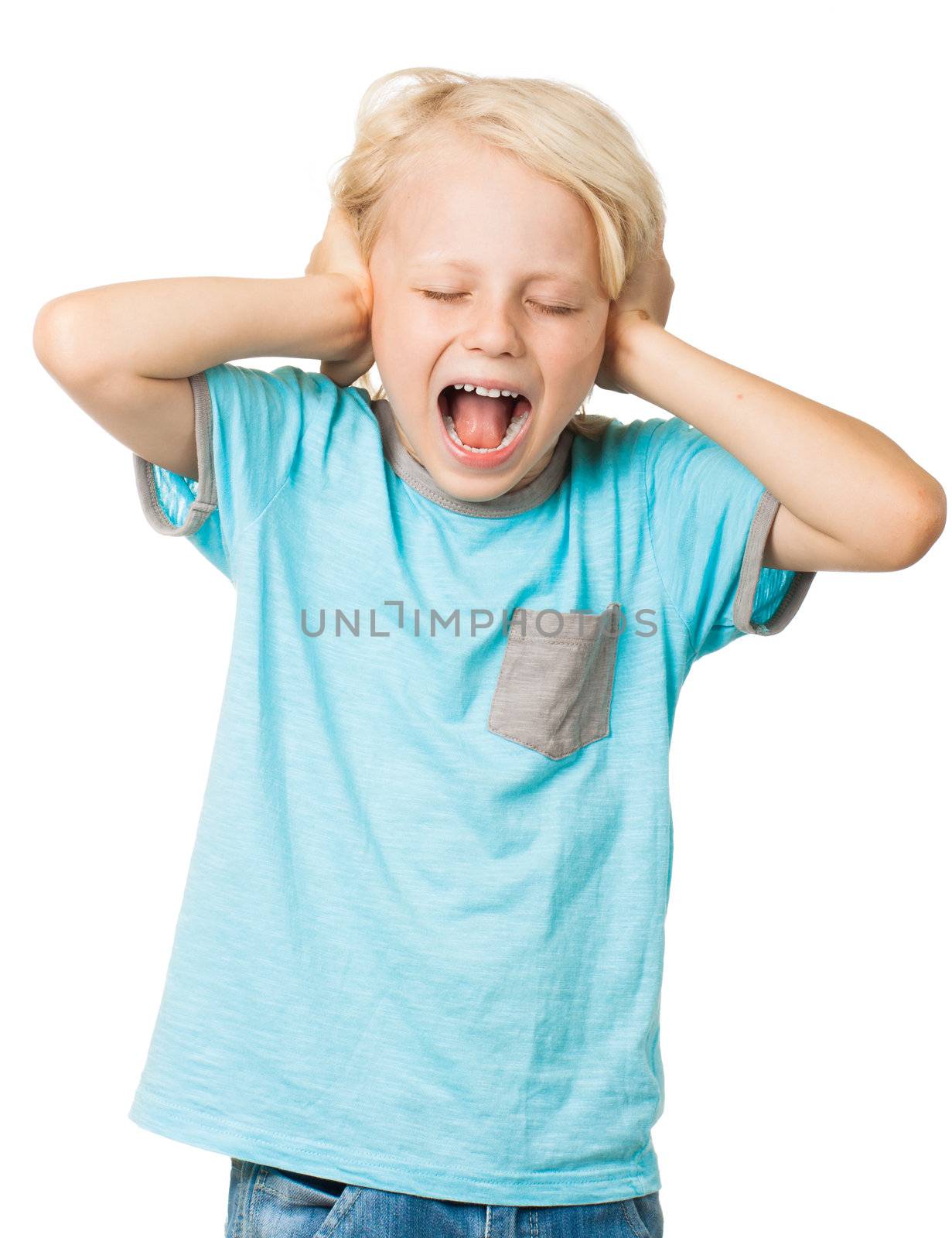 A young distressed young boy screams with his eyes shut and covers his ears with his hands. Isolated on white.