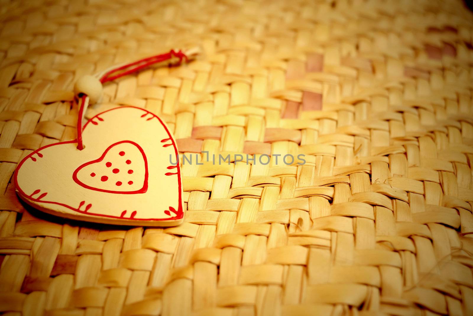 wooden heart on  hemp background and copy space