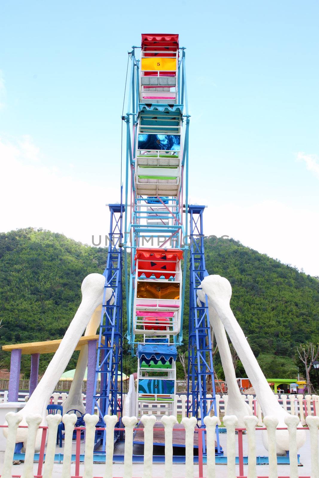 a colourful ferris wheel in the park (side view)