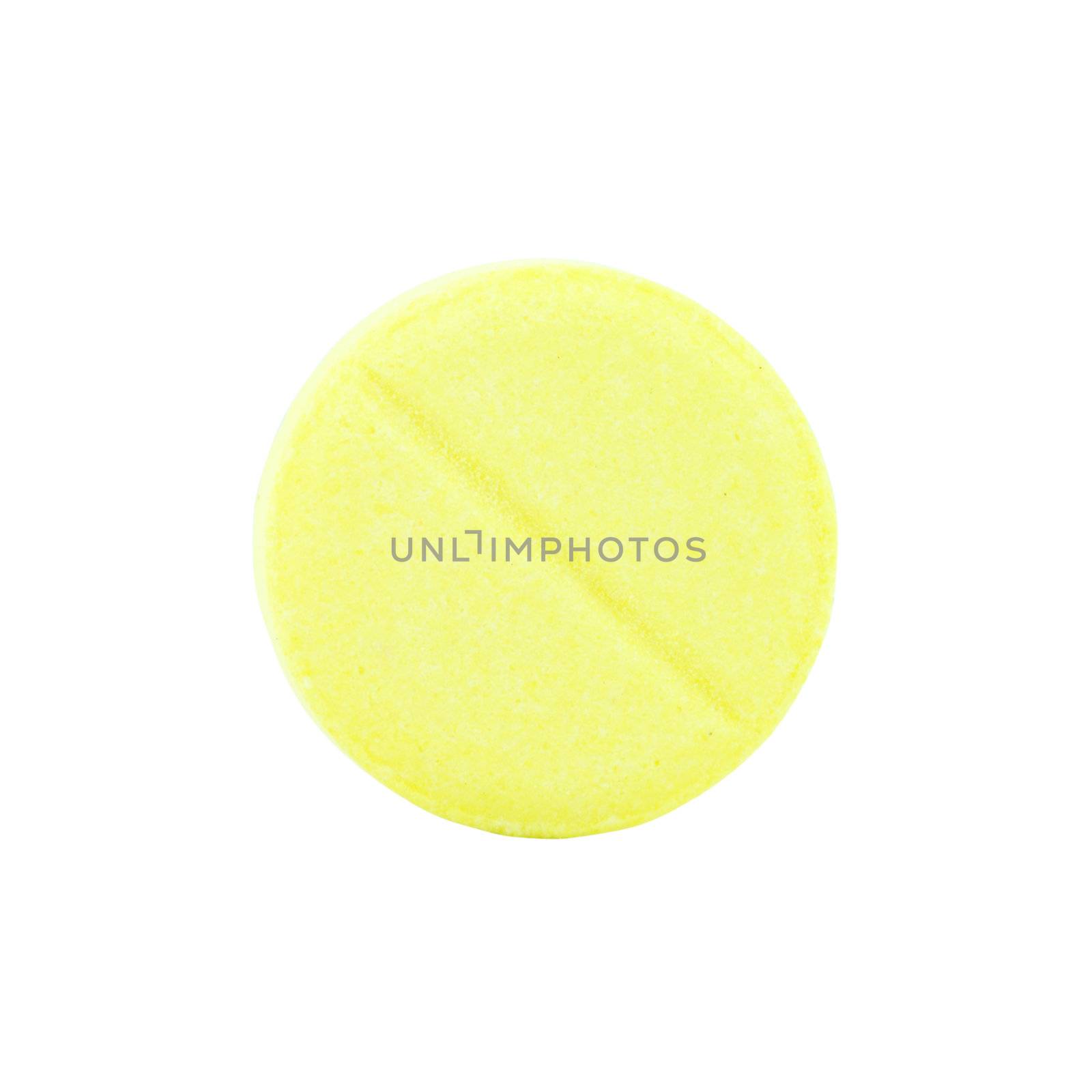 close-up of single yellow pill on white background