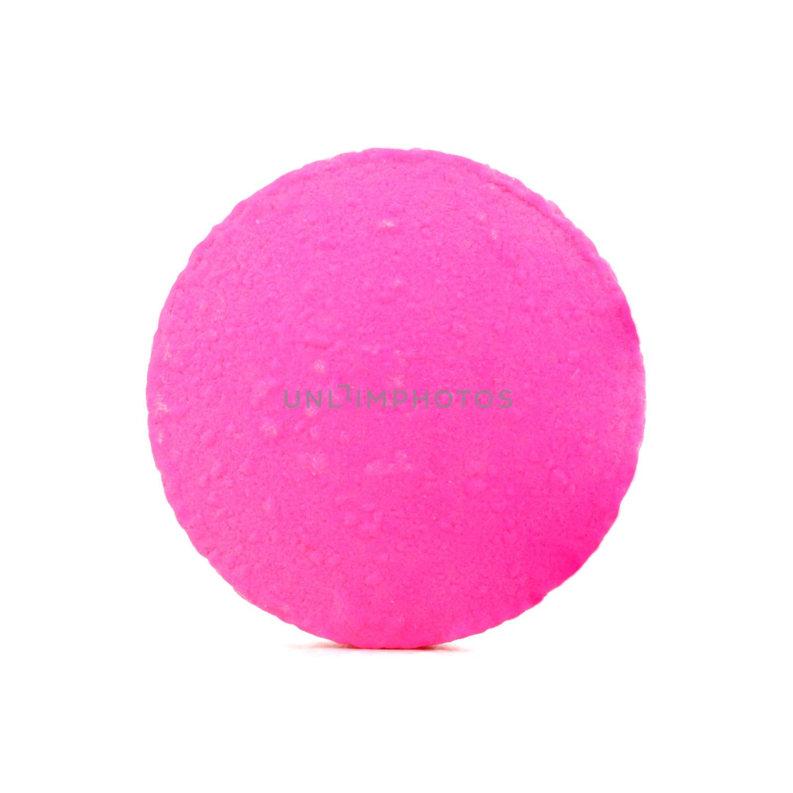 single pink pill on white background