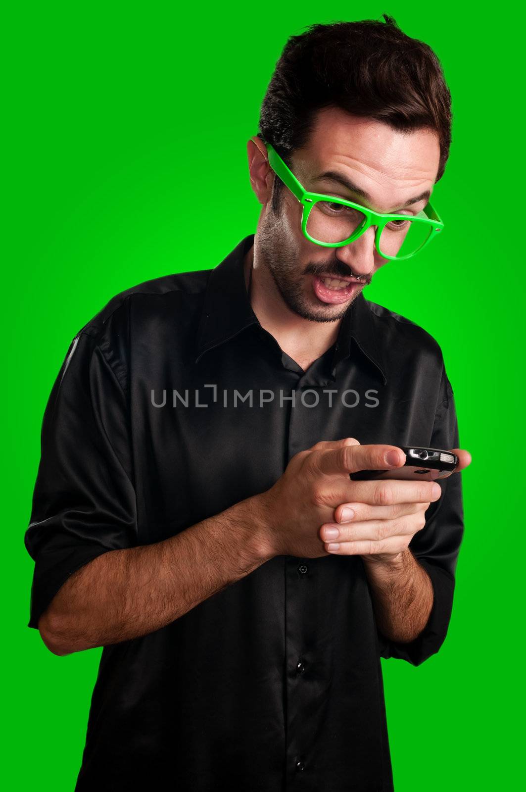 funny man holding phone on green background