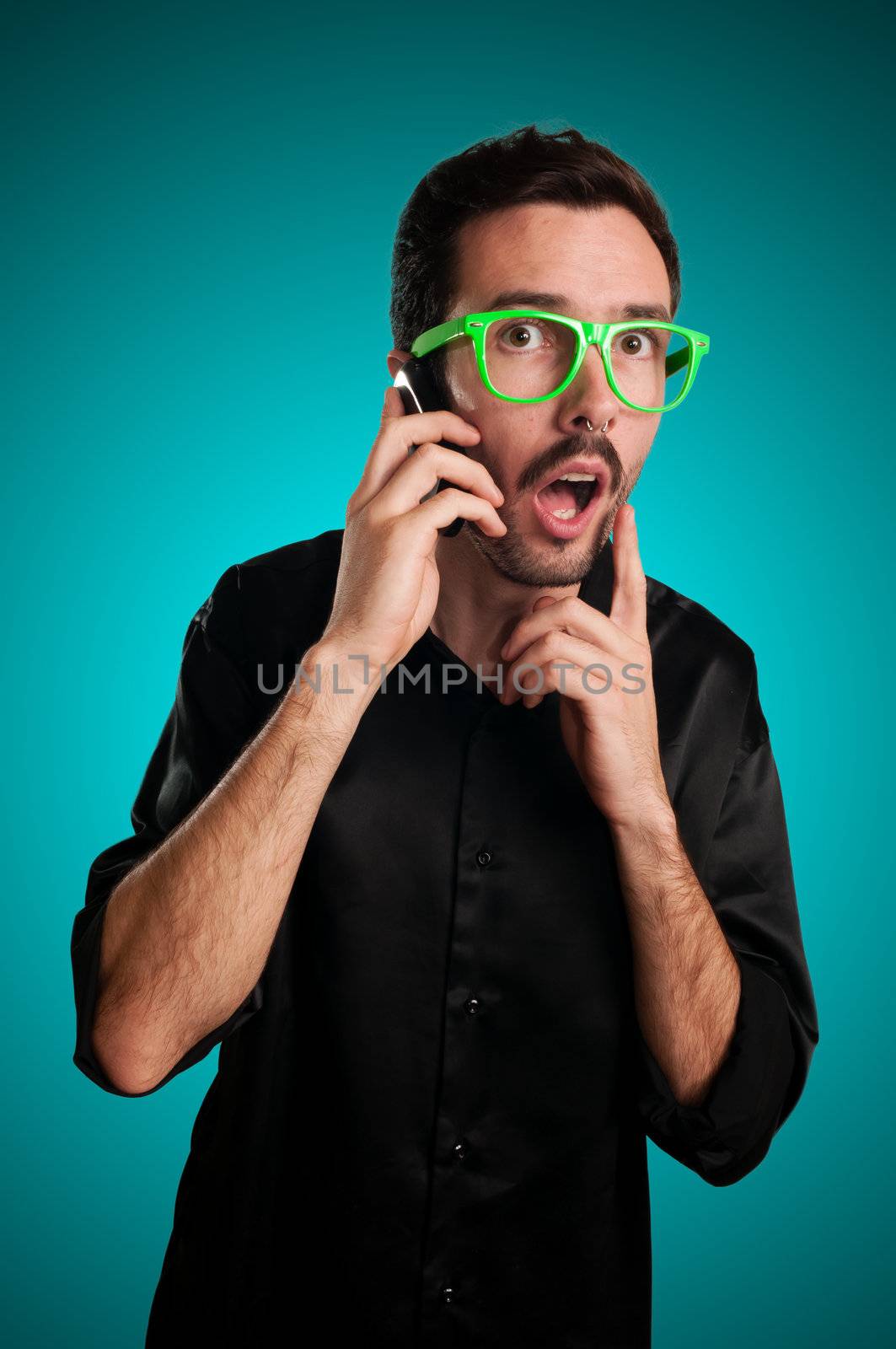 doubtful man holding phone on blue background