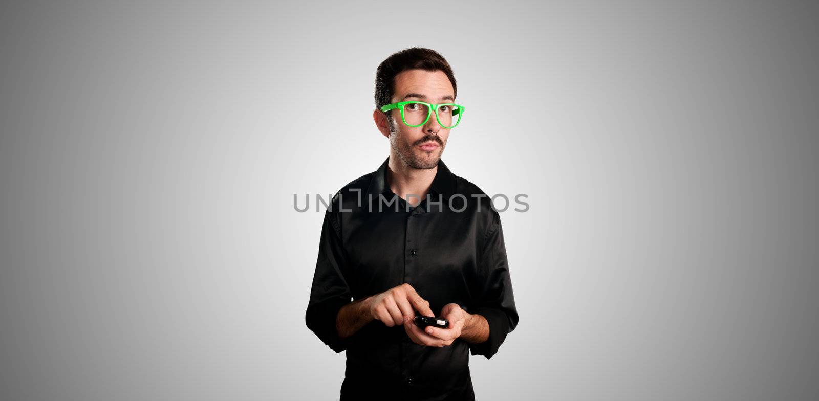 thinking man holding phone on gray background
