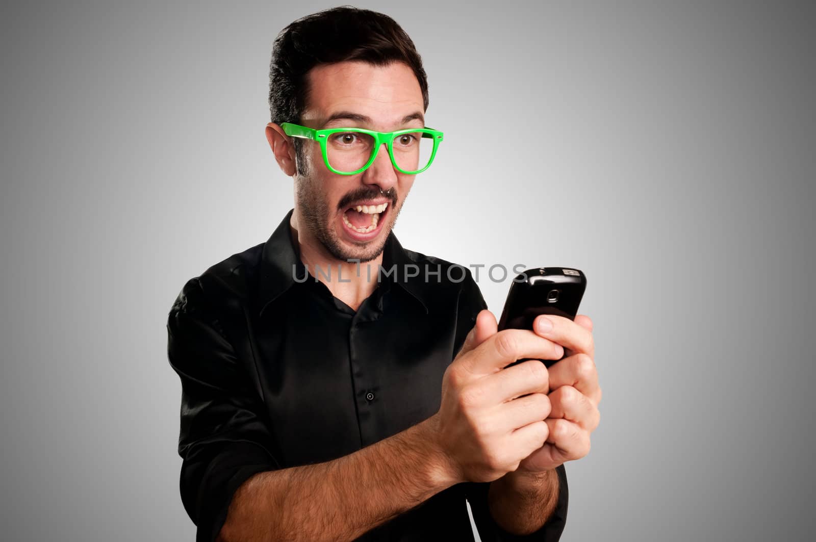 success man holding phone on gray background
