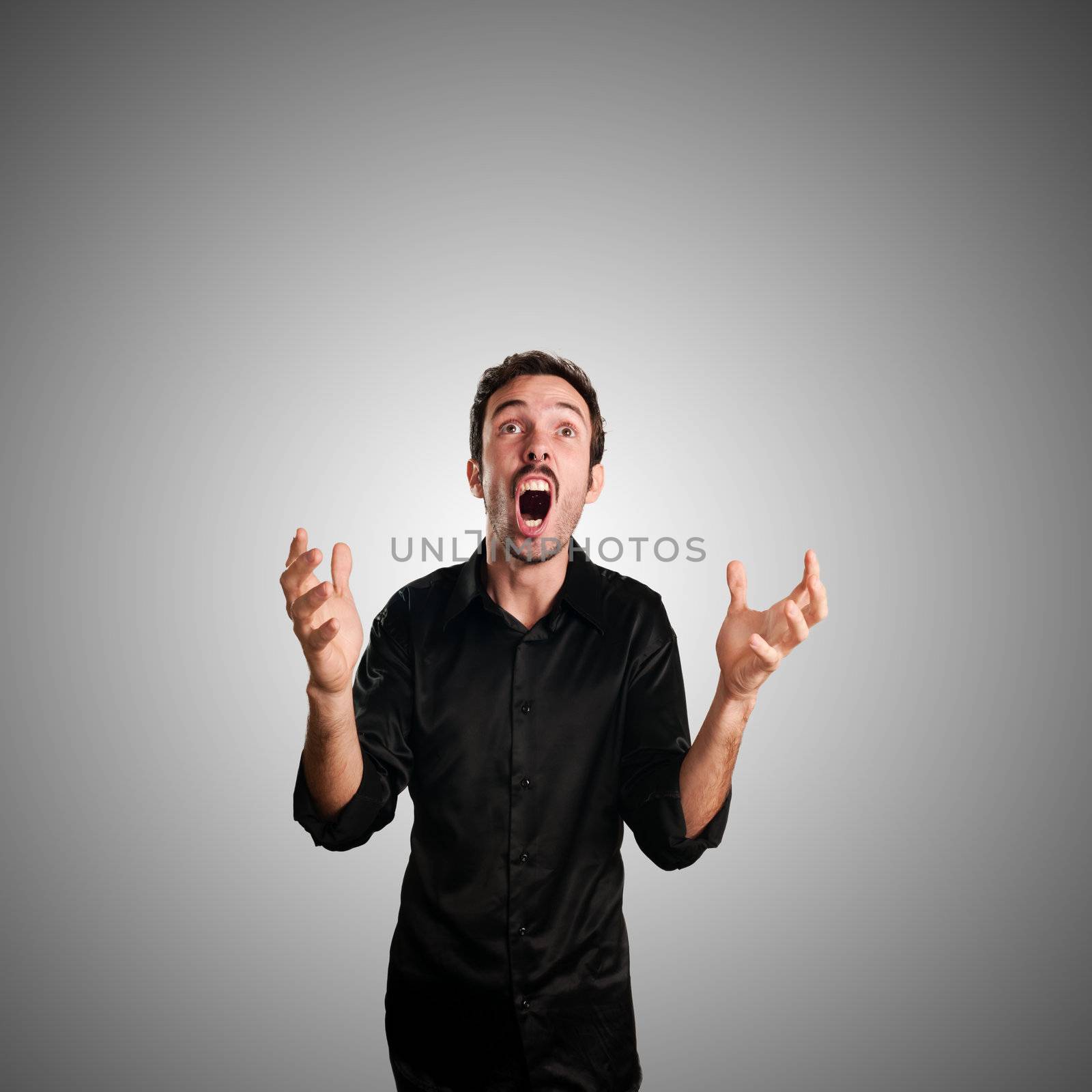 successful business man screaming on blue background