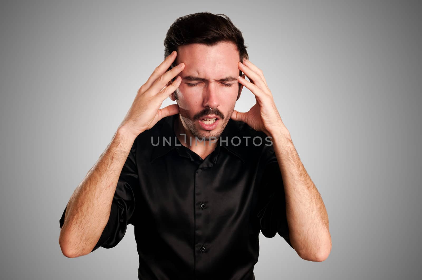 man with headache on gray background