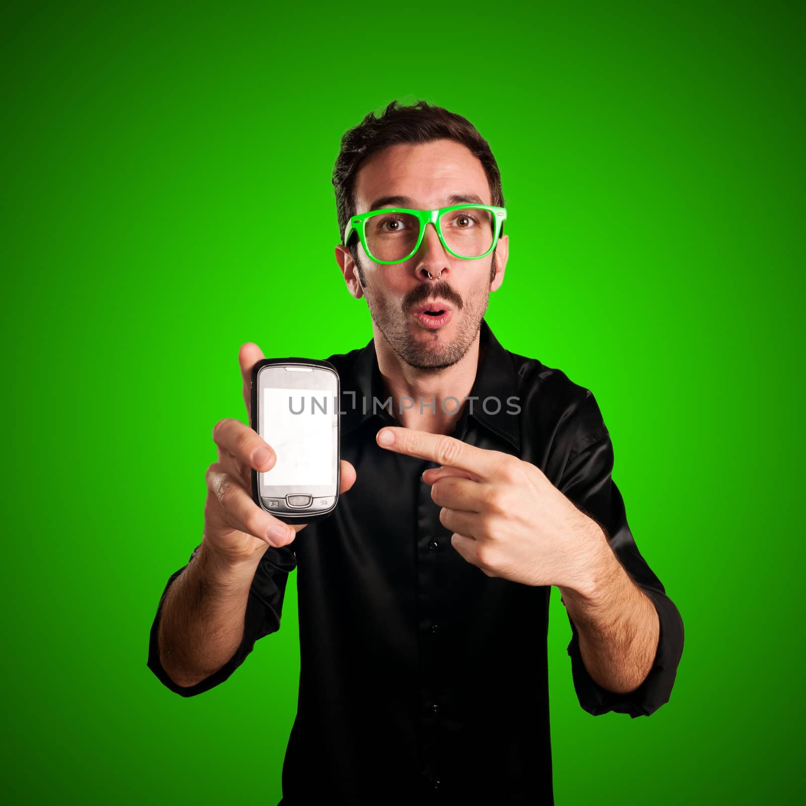 funny man holding phone on green background