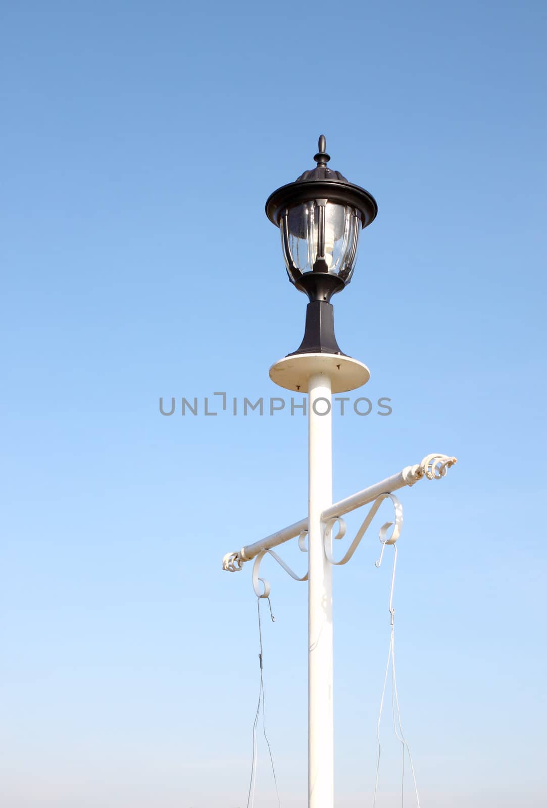 vintage lamp post against blue sky background