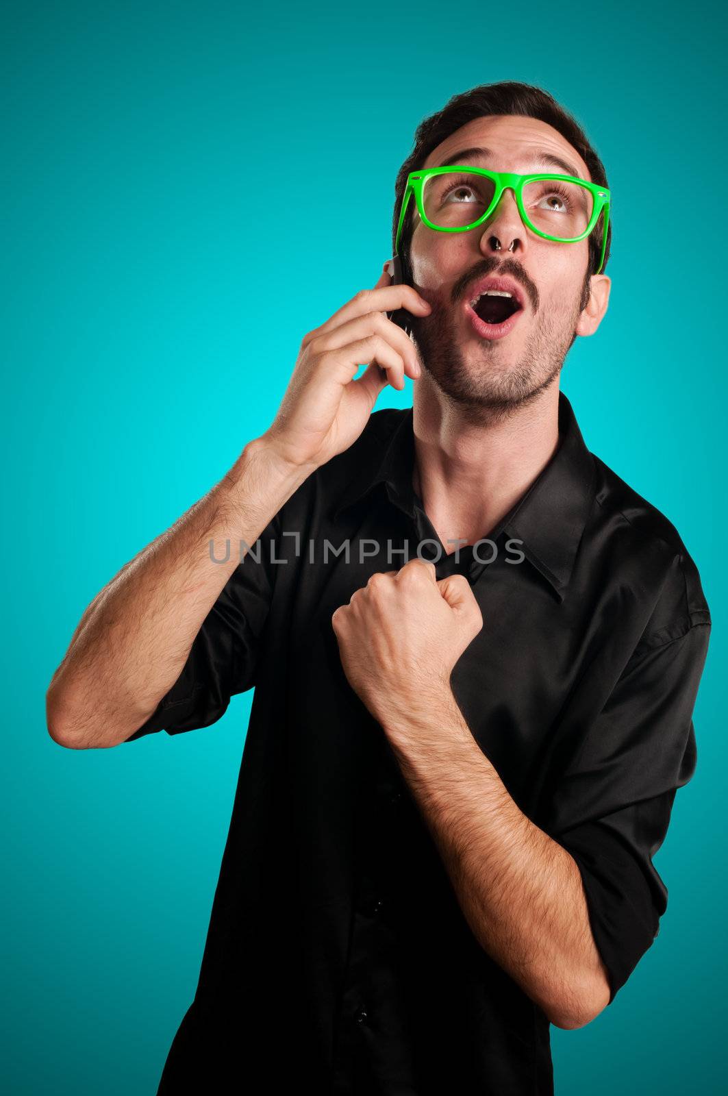 success man holding phone on blue background