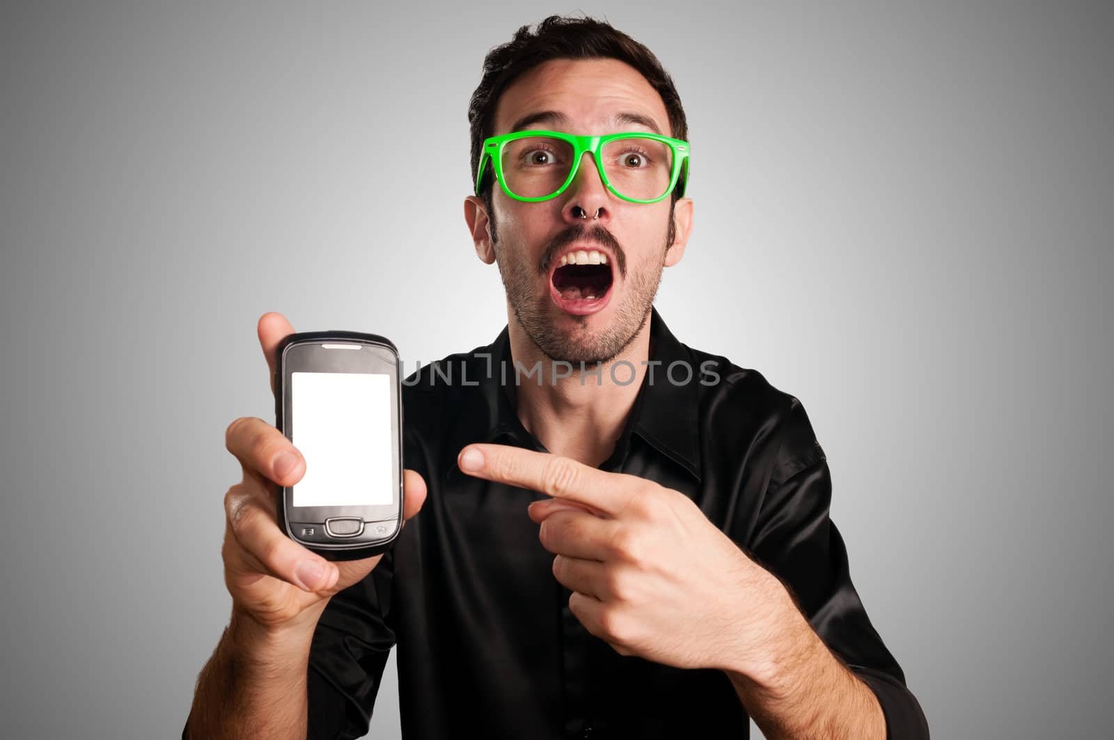 funny man showing phone on gray background
