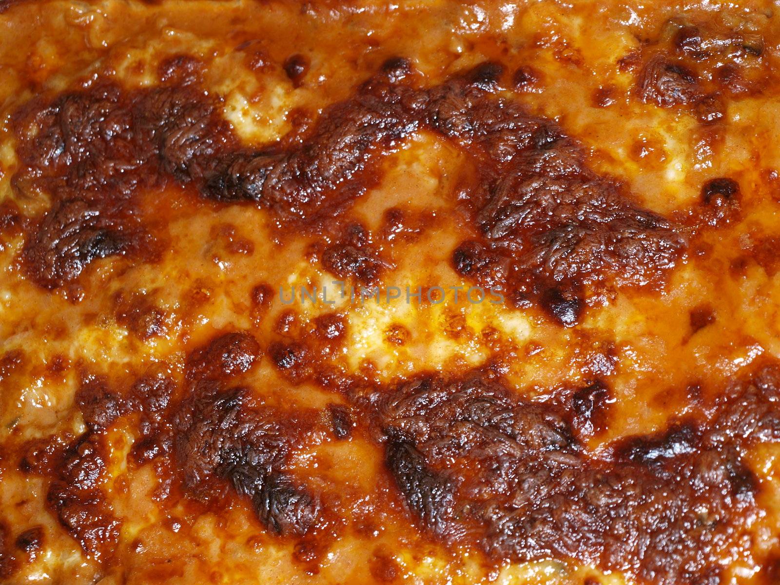 Closeup of melted cheese, brown and crusty