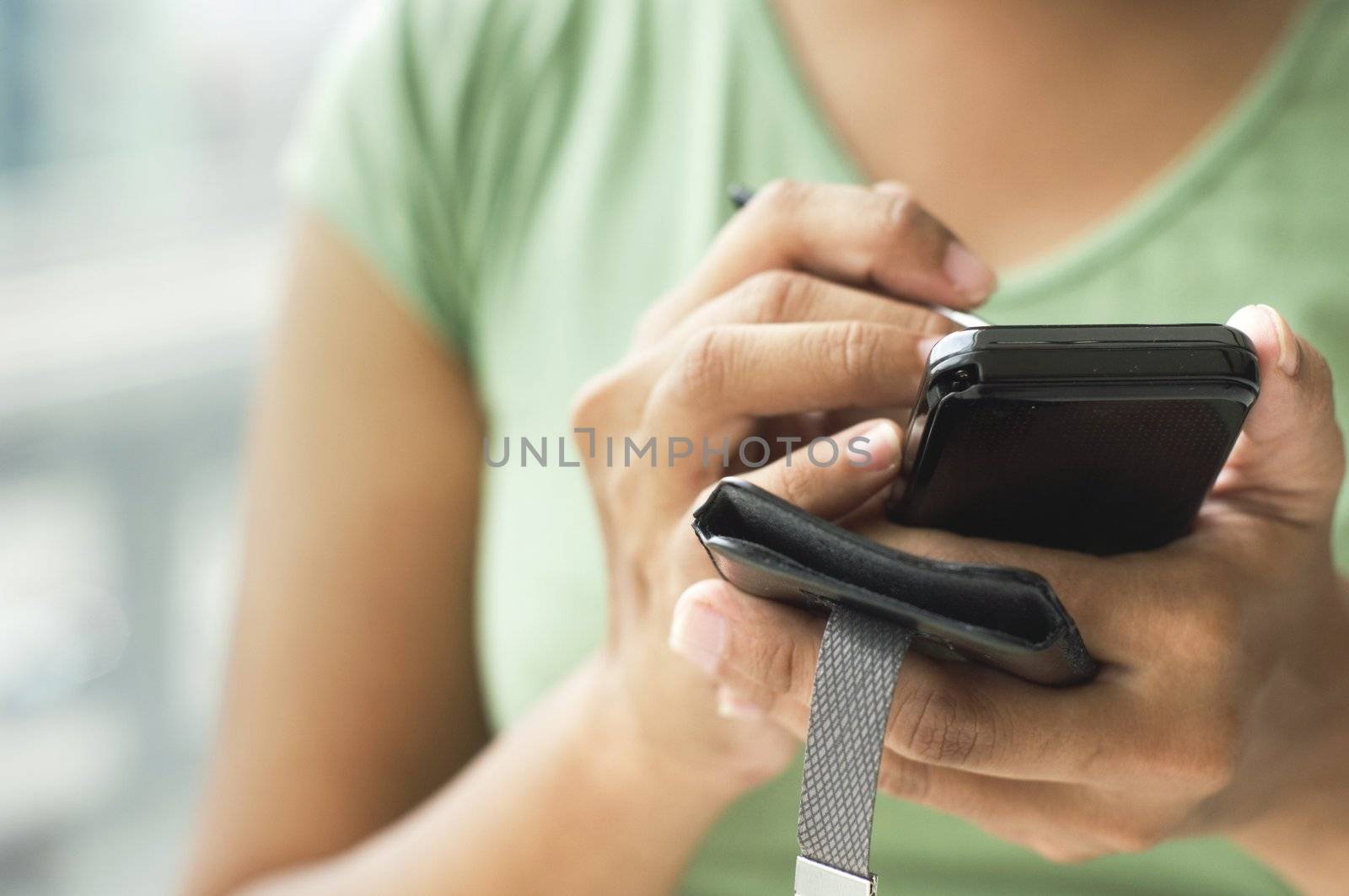 close up of a woman using her smartphone or cellphone.