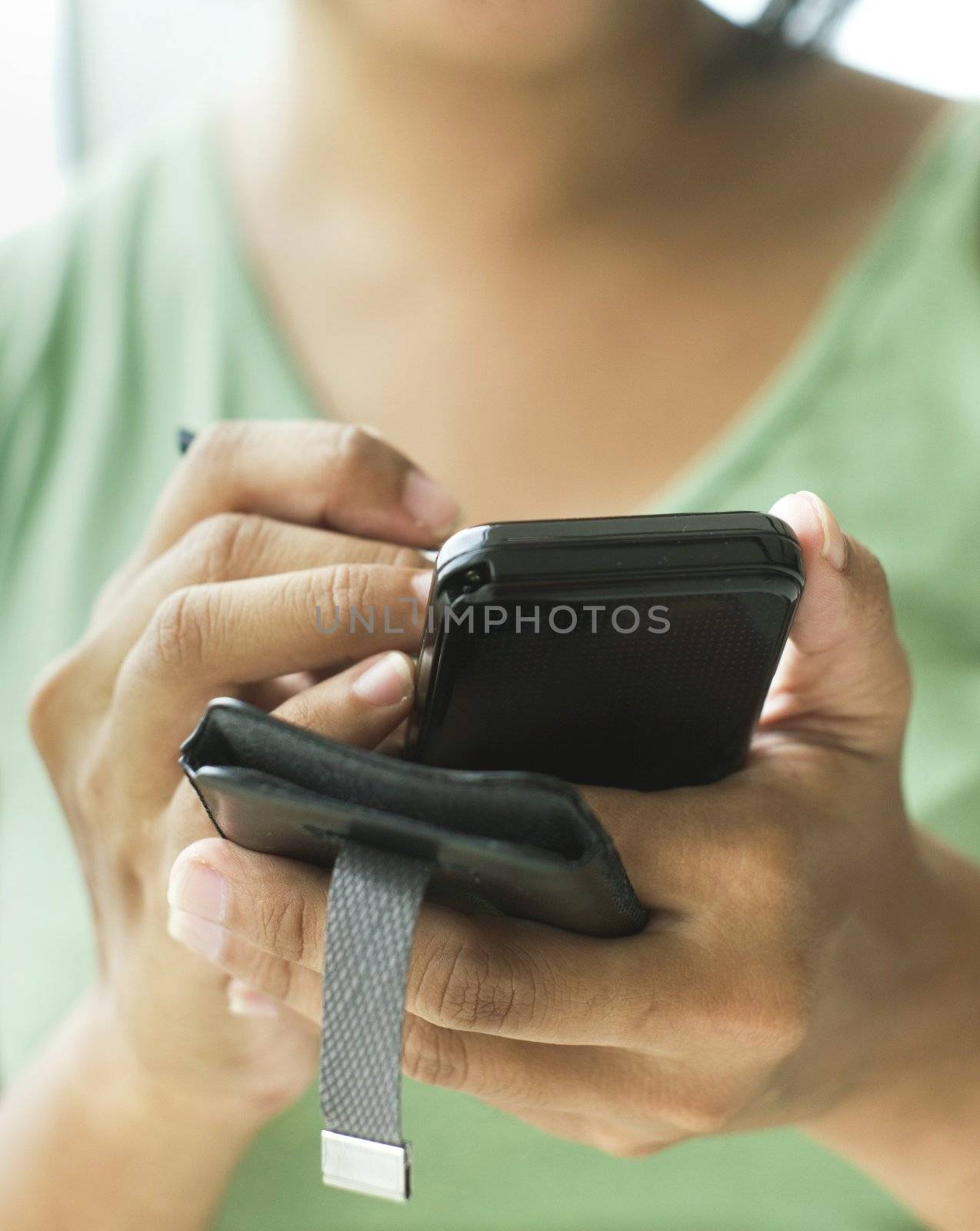 close up of a woman using her smartphone or cellphone.