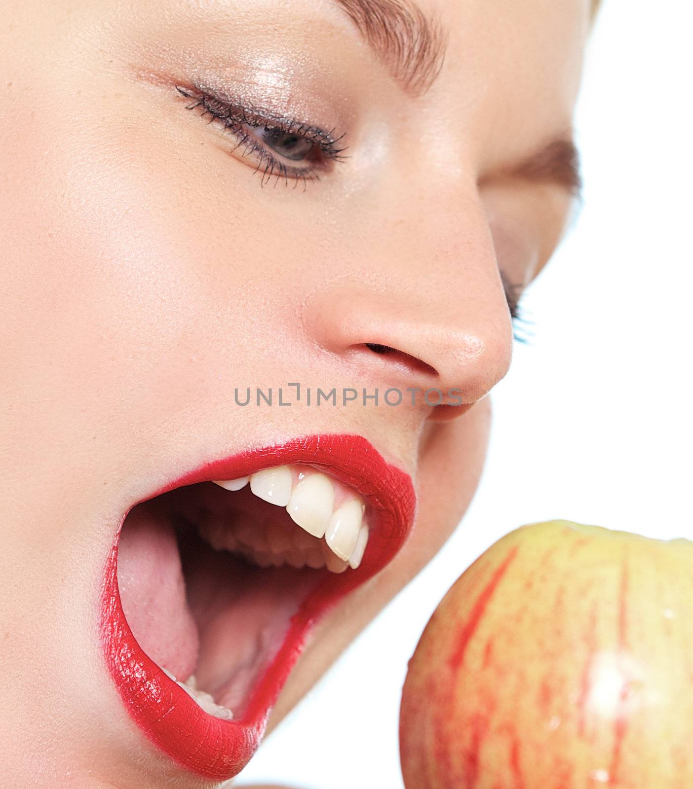 Close up of woman opening mouth to apple