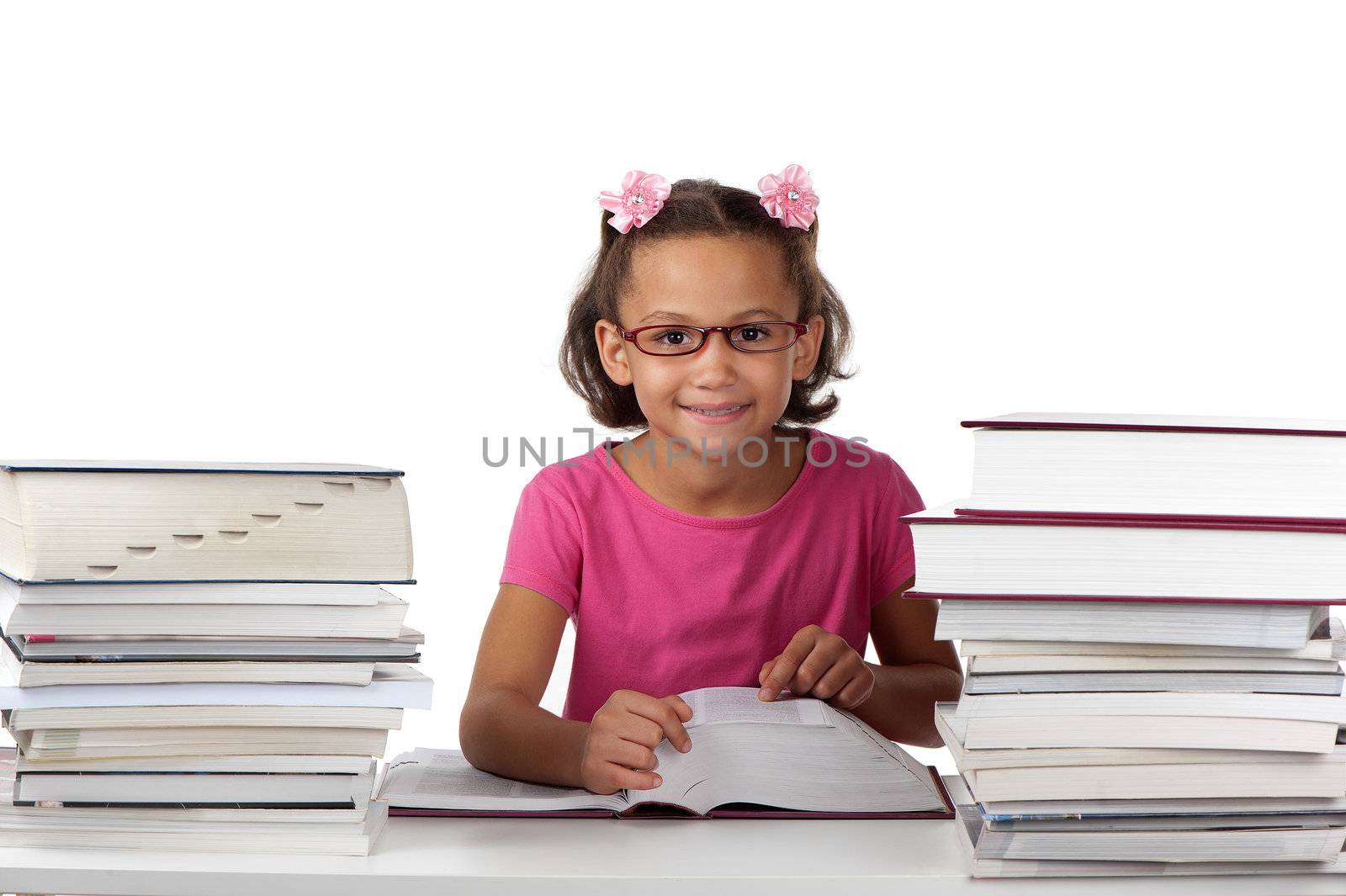 A young girl with spectacles enjoys studying large volumes of books.