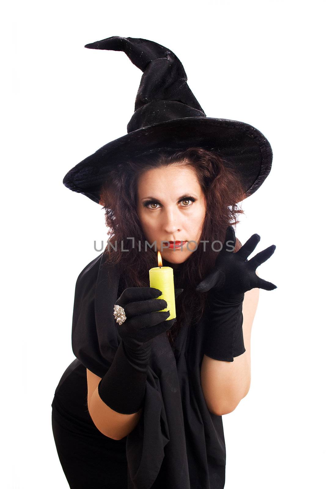 Witch with a candle casts a spell