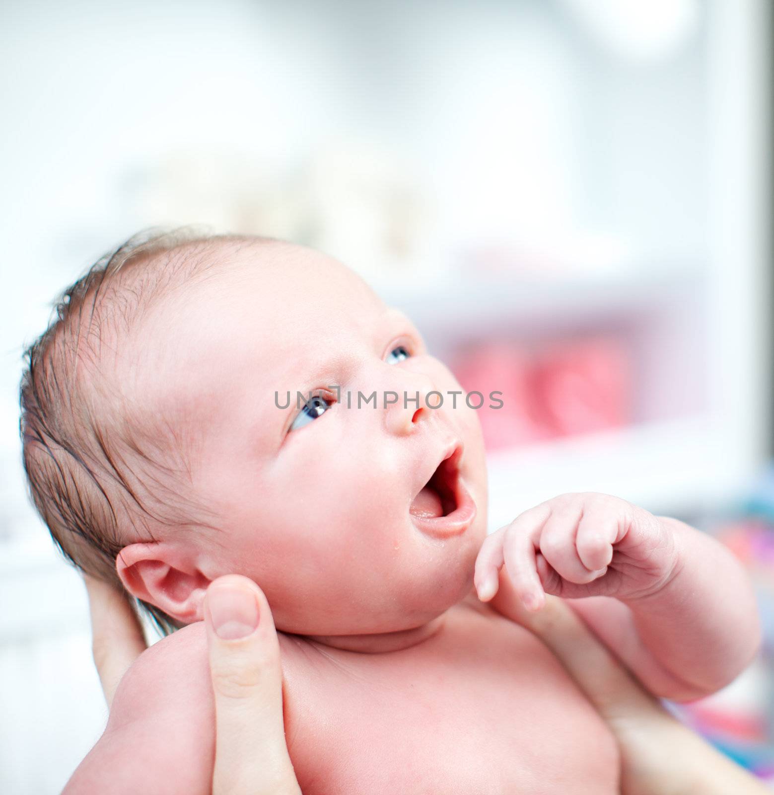 Newborn baby with look of wonderment by langstrup