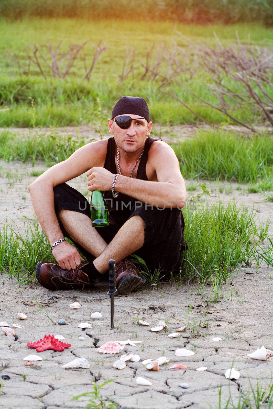 Pirate on land with a bottle of rum, threatening look