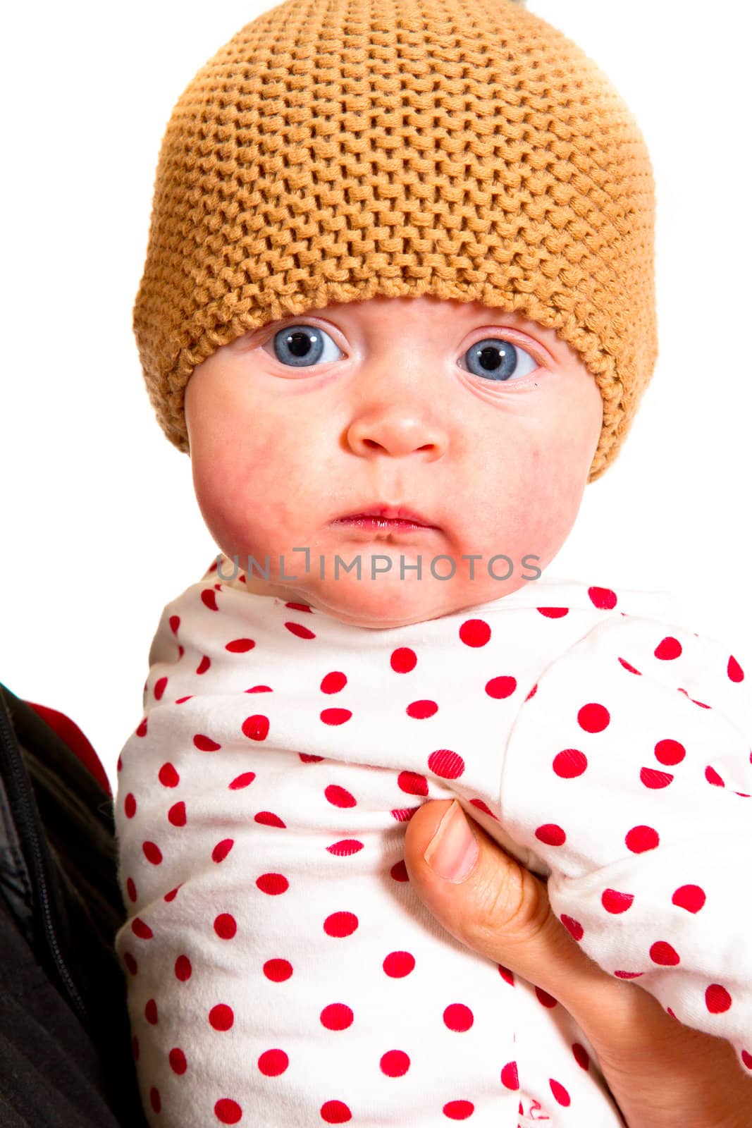 A newborn baby girl with her parents in the studio for a portrait.