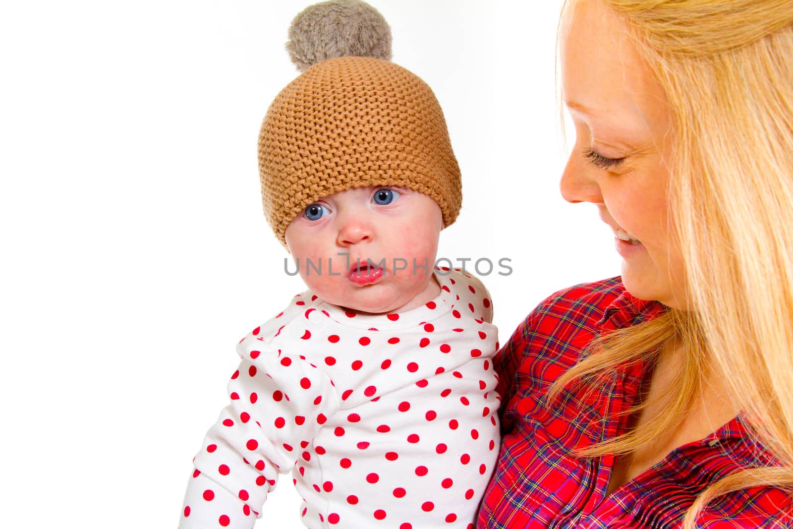 A newborn baby girl with her parents in the studio for a portrait.