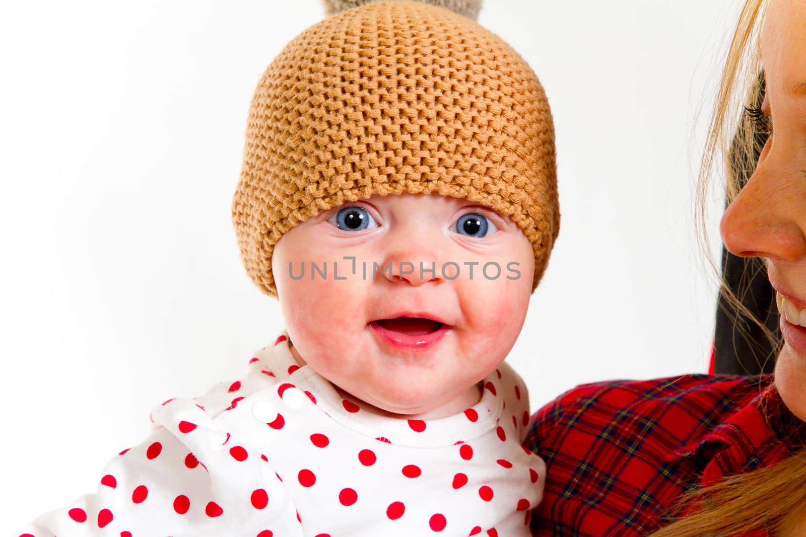 A newborn baby girl with her parents in the studio for a portrait.