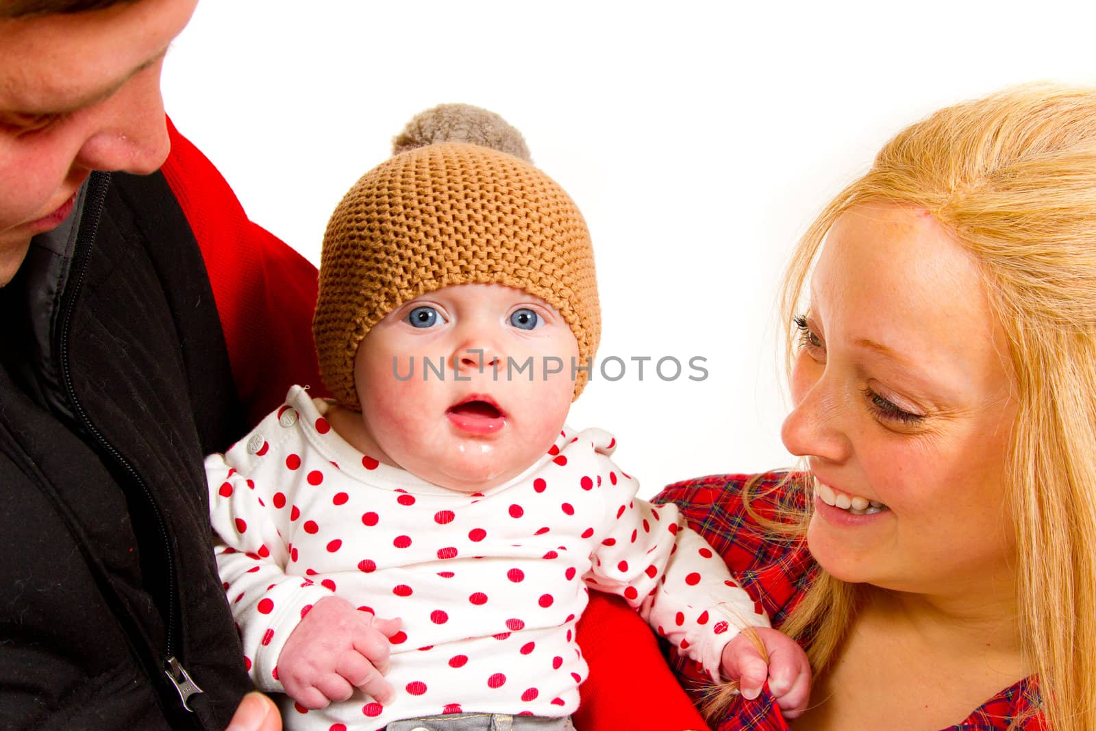 A newborn baby girl with her parents in the studio for a portrait.