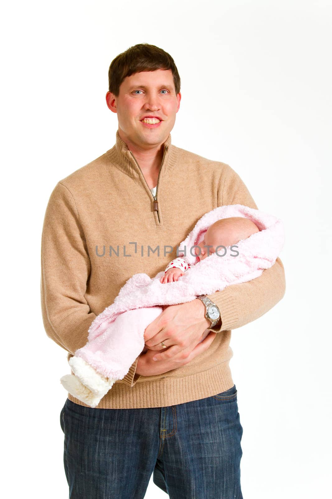 A family portrait of three people in the studio including mother father and newborn baby girl.