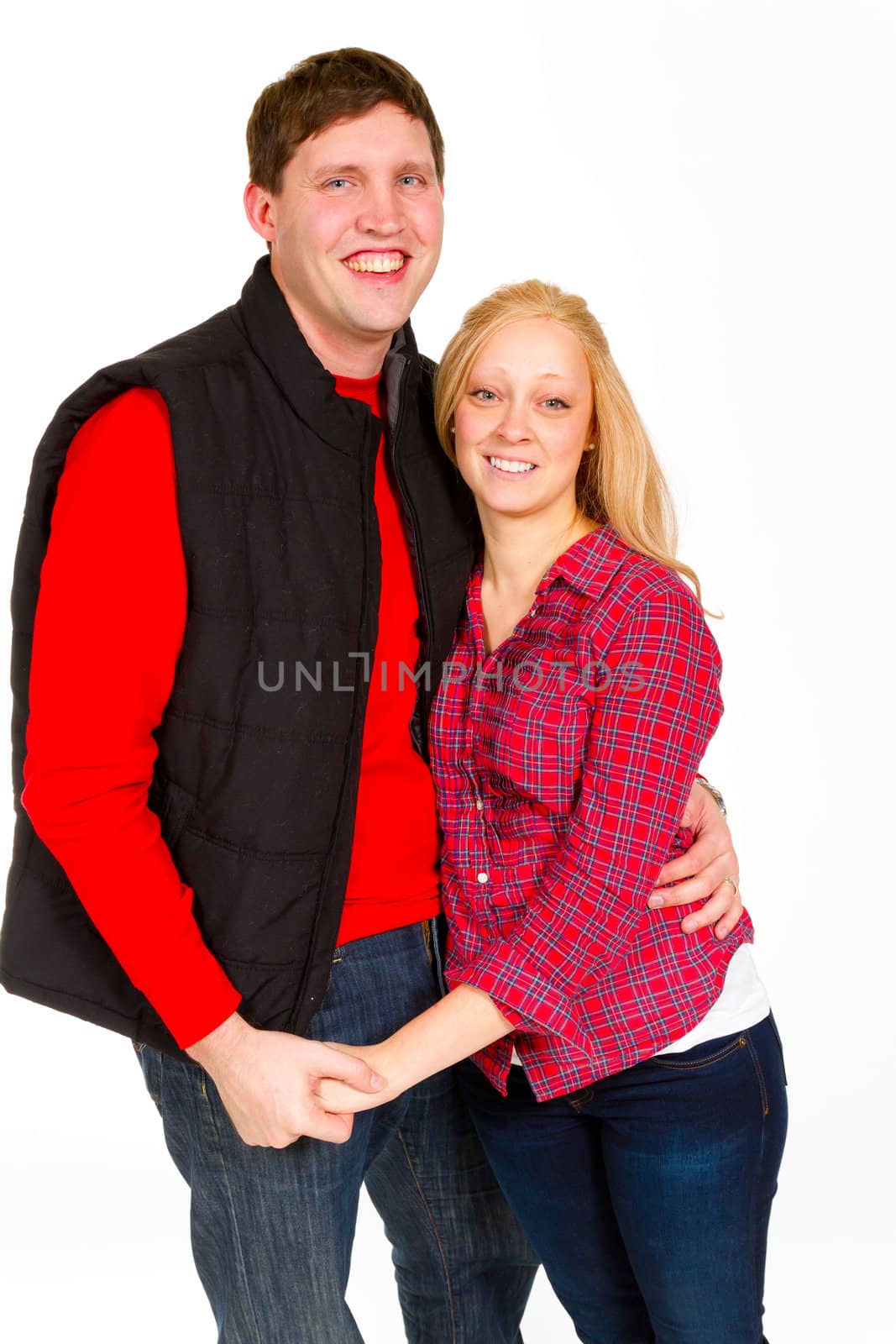 An attractive couple is photographed for a studio portrait on a white background.