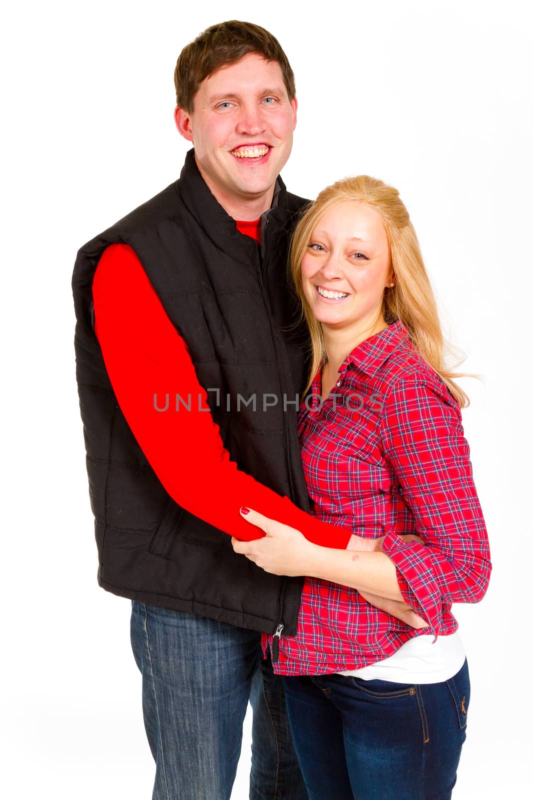An attractive couple is photographed for a studio portrait on a white background.