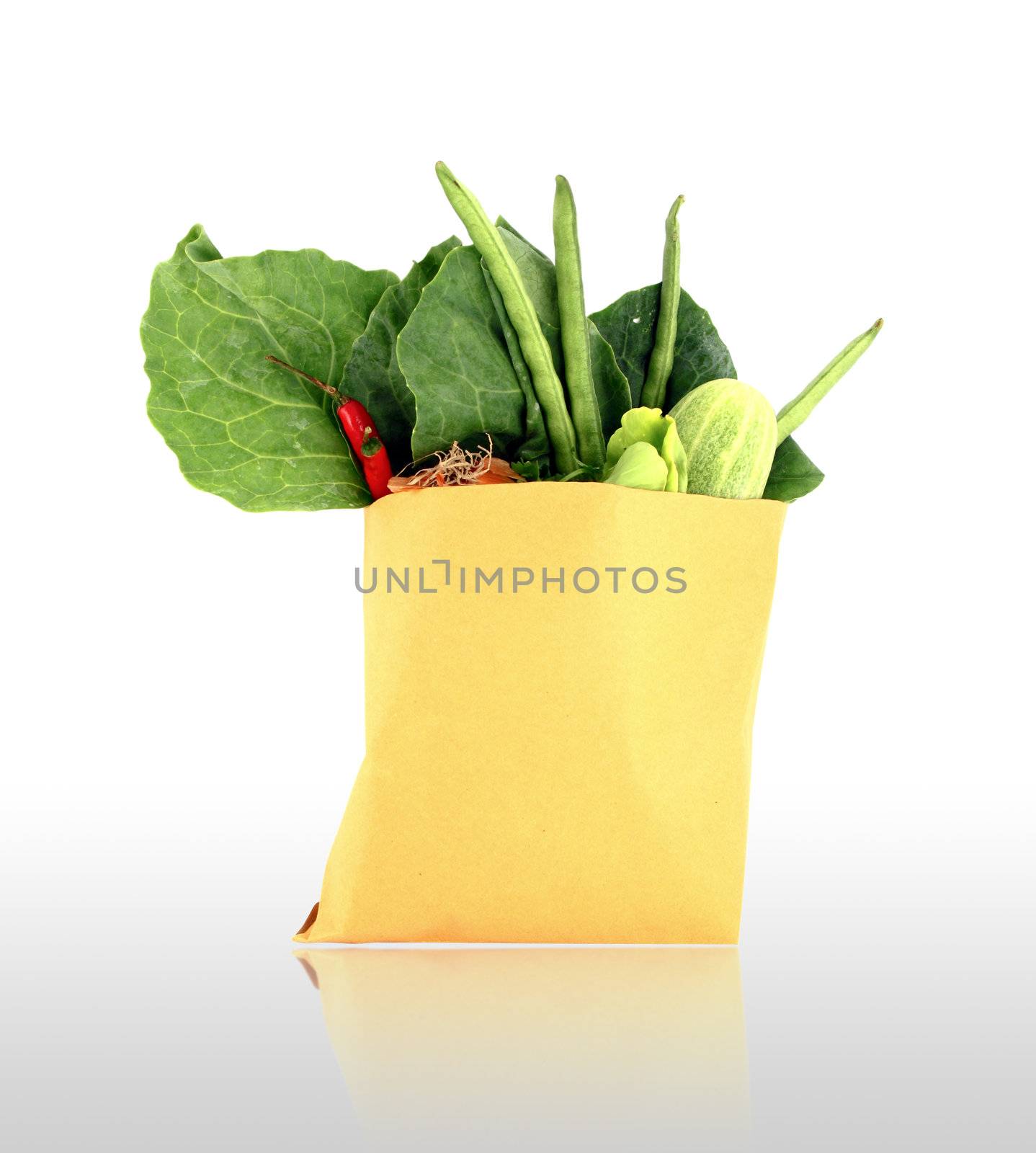 Assorted vegetables in brown bag with shadow