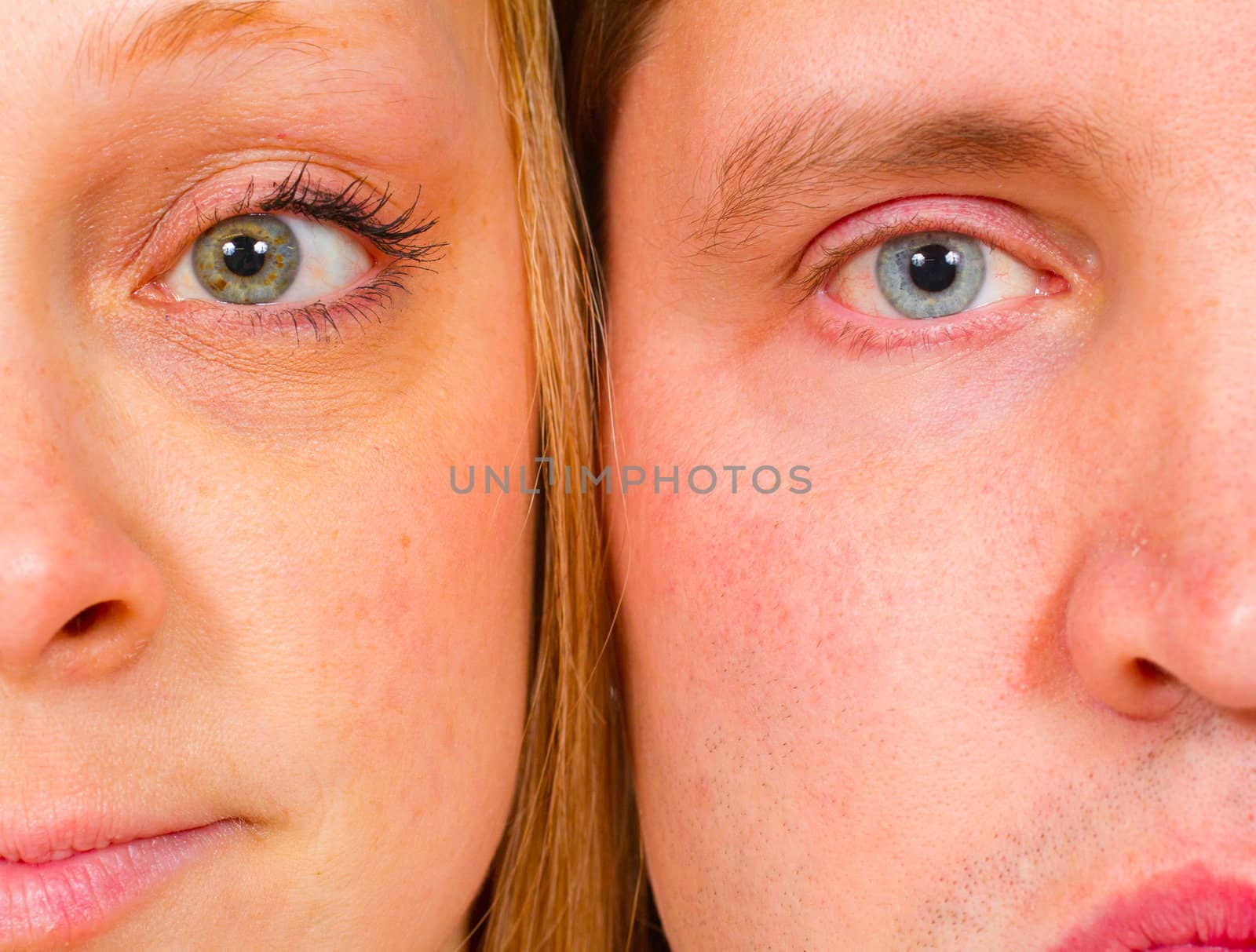 An attractive couple is photographed for a studio portrait on a white background.