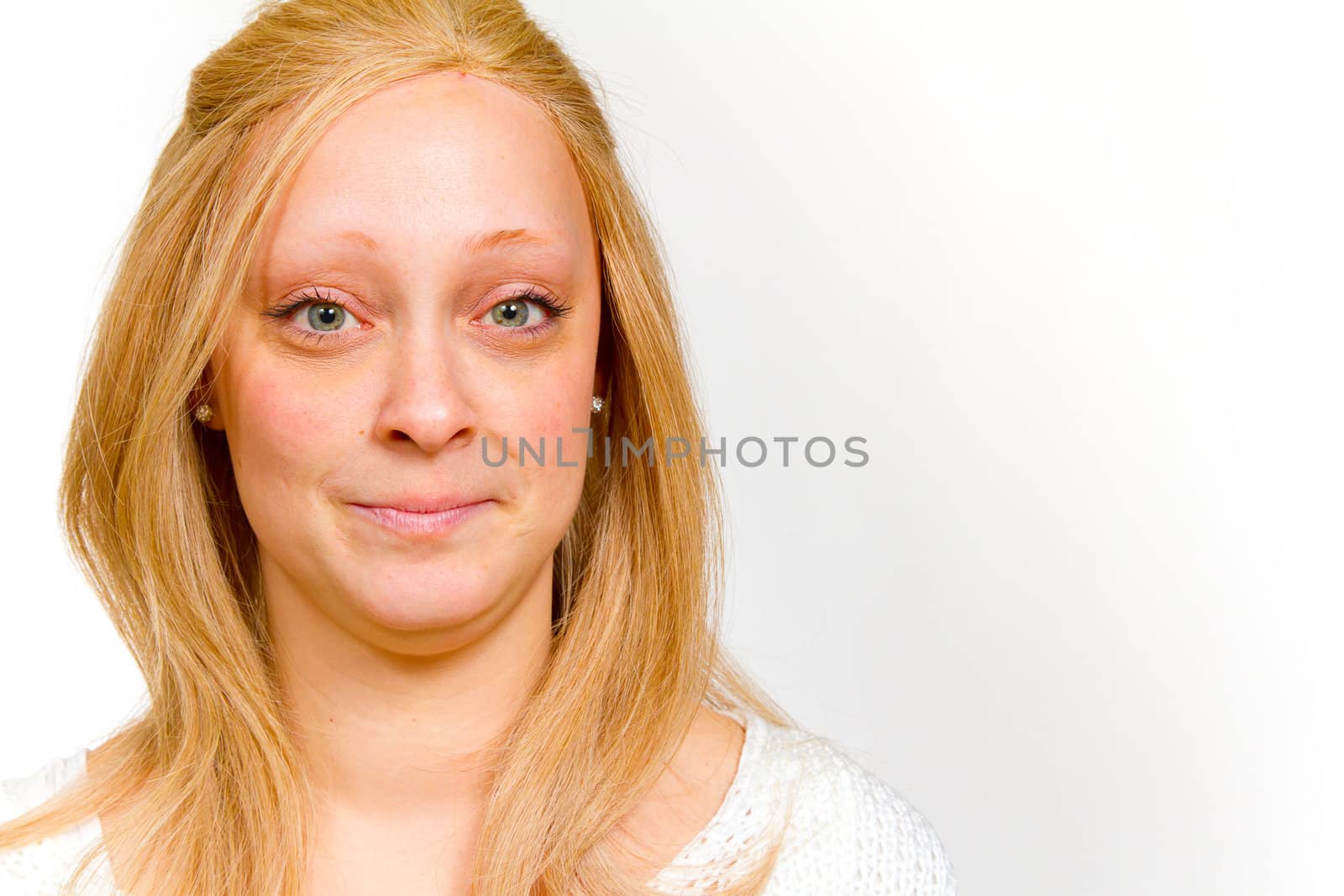 An attractive girl is photographed in the studio with a white background for this portrait.