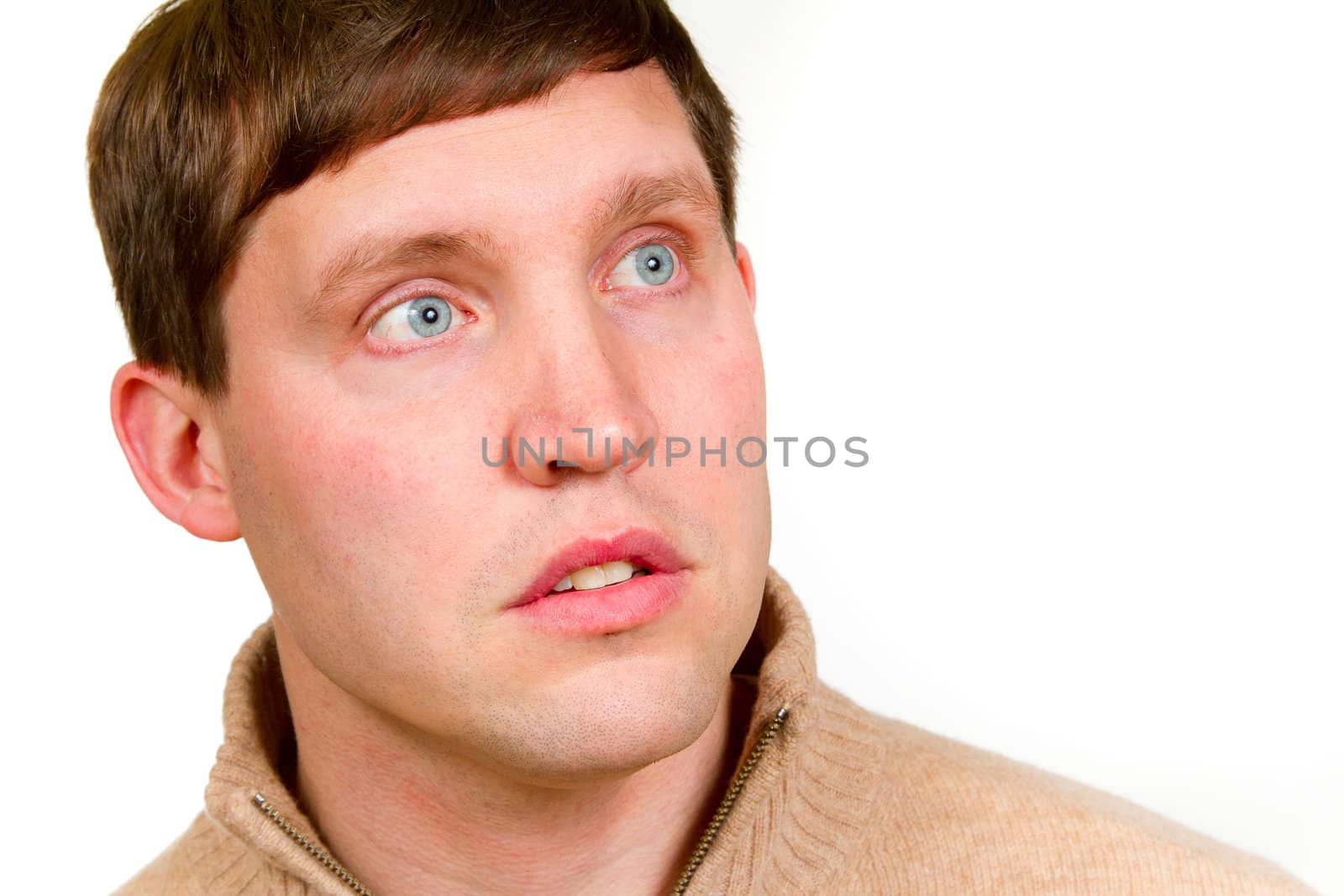 An attractive man is photographed against a white background in the studio for this portrait.