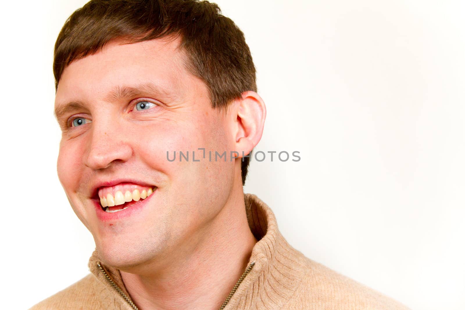 An attractive man is photographed against a white background in the studio for this portrait.