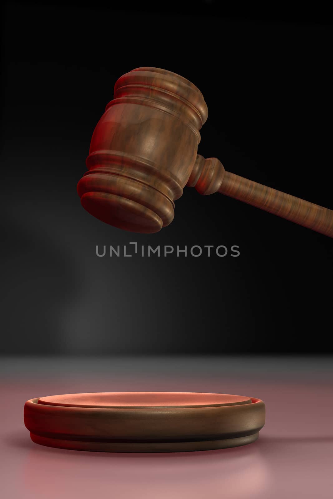 Judge's gavel up illuminated with red light on black background