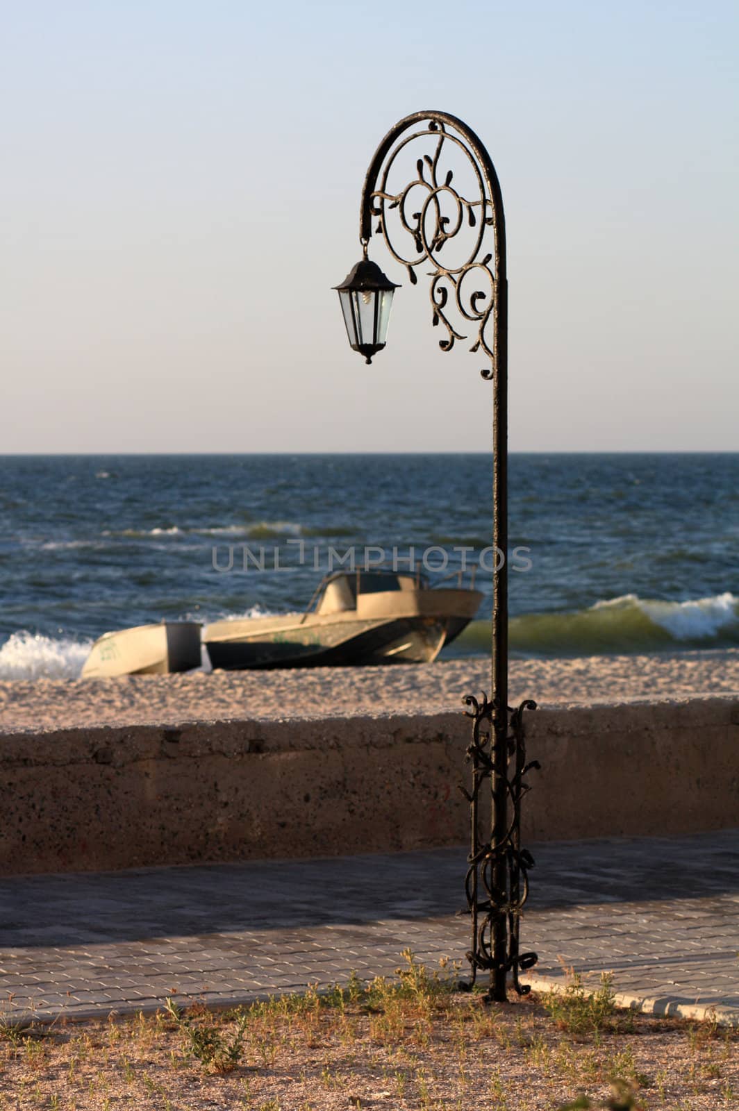 Forged park street lantern  on the beach with a boat and a pinna by pt-home