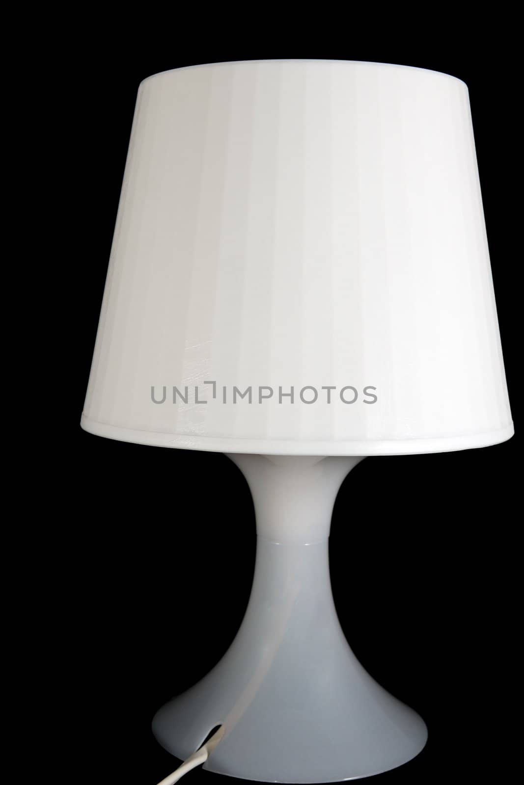 White desk lamp isolated on black background